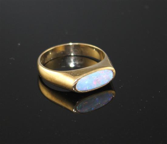 A modern 9ct gold and collet set white opal set dress ring, size M, gross weight 3.9 grams.
